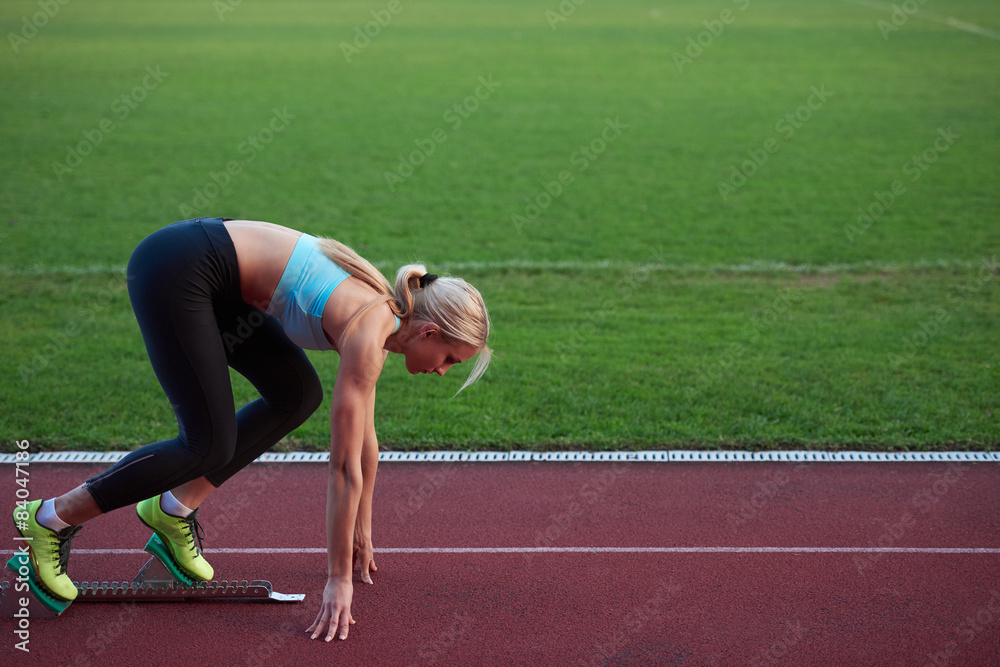 woman  sprinter leaving starting blocks