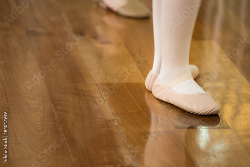 ballet dancer feet on wooden floor