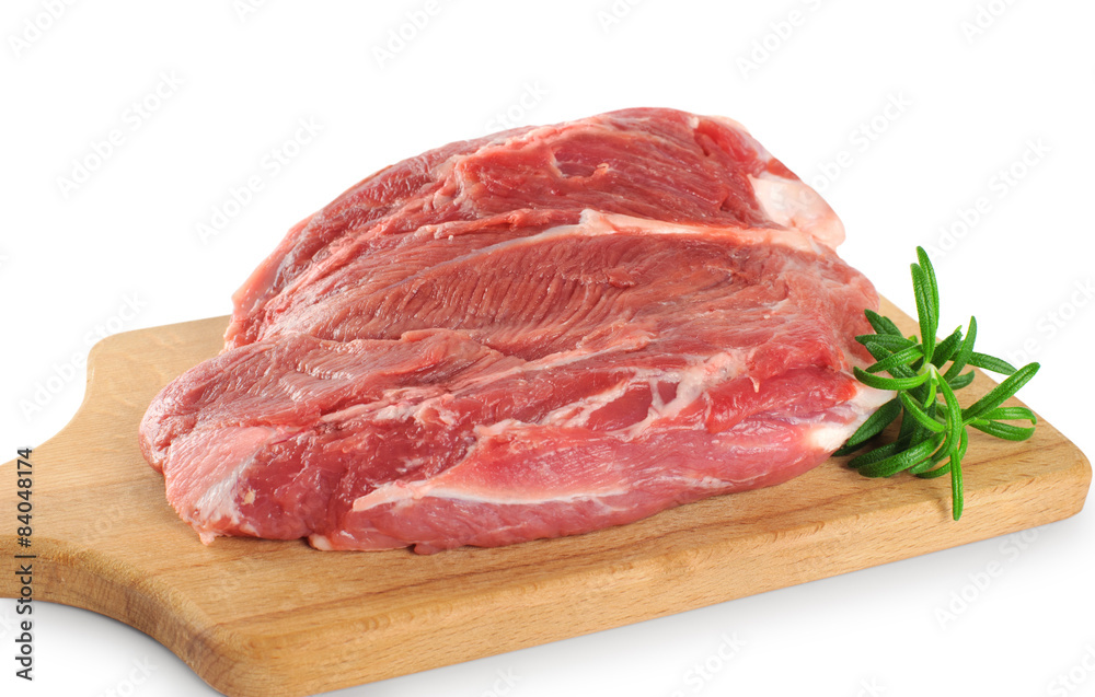 Fresh raw meat and rosemary on a wooden board