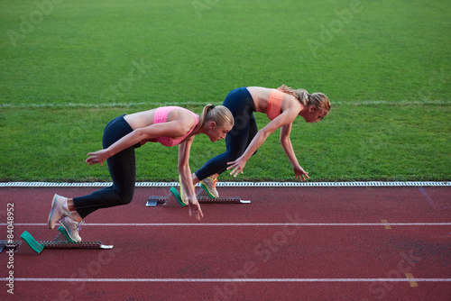 athlete woman group running on athletics race track