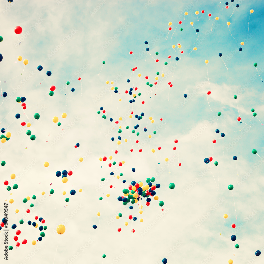 A lot of balloons over a retro sky