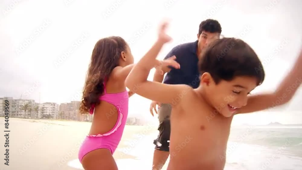 Brazilian Family plays on a beach in Brazil Brazilian Family plays on a beach in Brazil