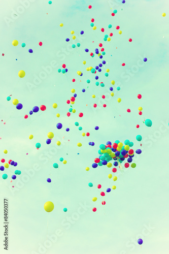 A lot of balloons over a retro sky