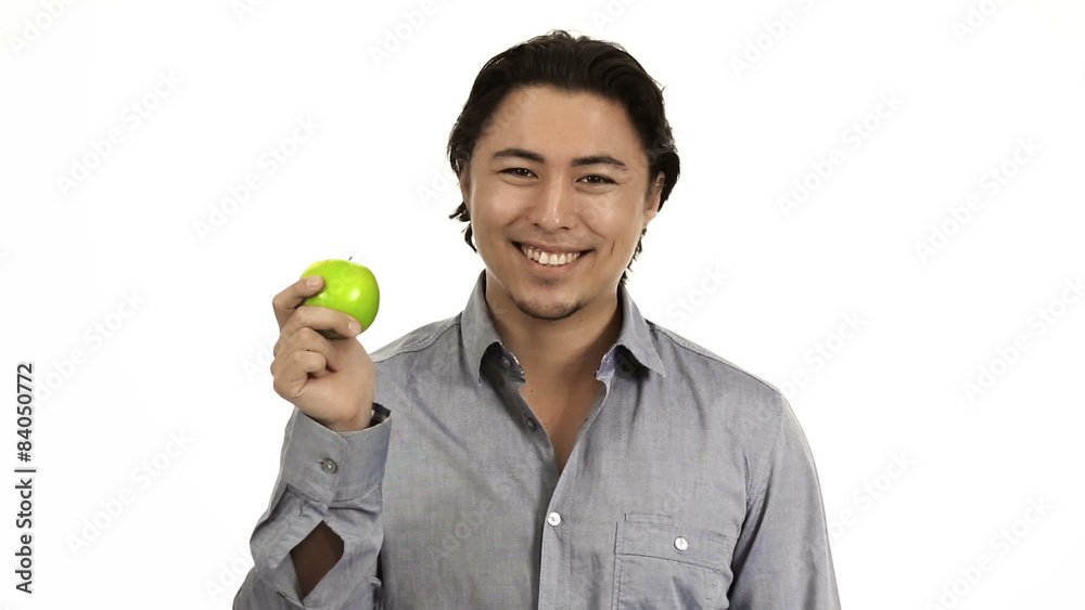 Attractive man wearing a shirt holding a green apple Attractive man wearing a shirt holding a green apple