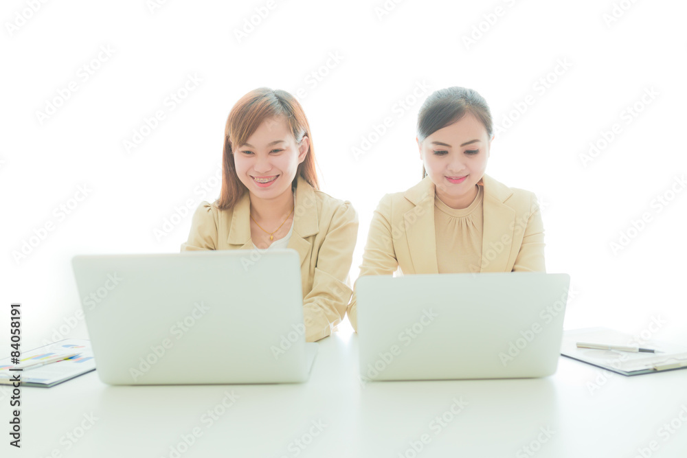 Two Pretty Smiling Businesswomen Discussing 