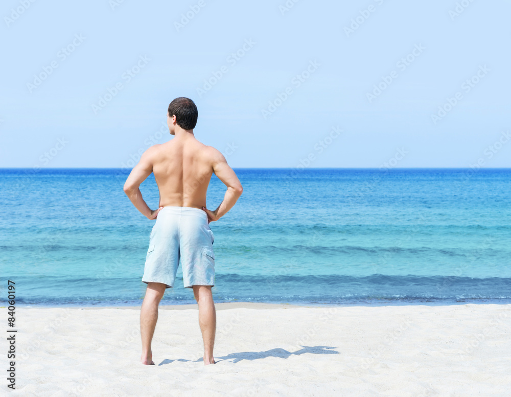 Young and handsome man on a summer beach