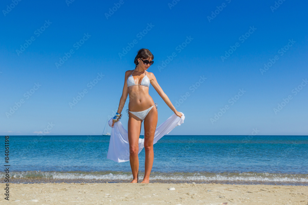 happy sexy girl in bikini posing at the beach