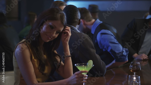 A guy at a bar meets a young woman then flirts with her