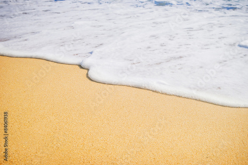 Close-up of a water edge and sand. Summer beach background