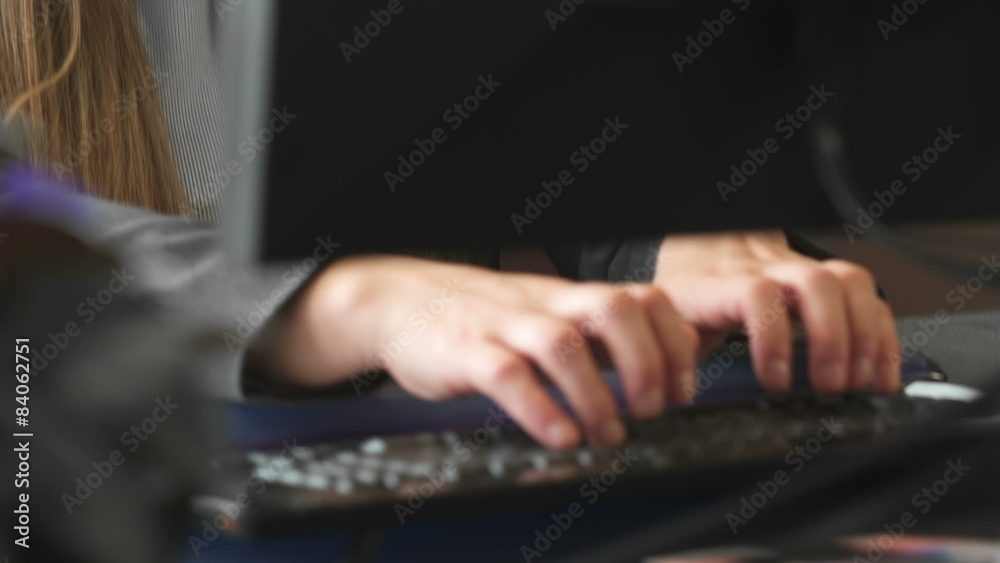 An attractive young businesswoman works alone and then smiles at the camera. An attractive young businesswoman works alone and then smiles at the camera.