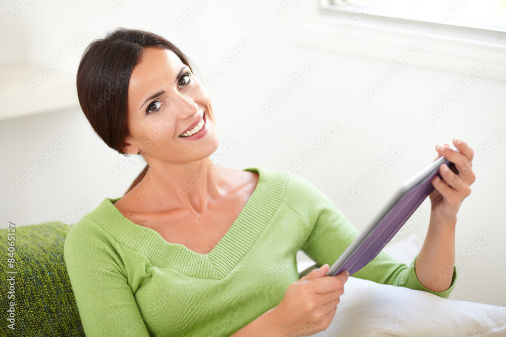 Attractive woman holding a tablet at indoors Attractive woman holding a tablet at indoors