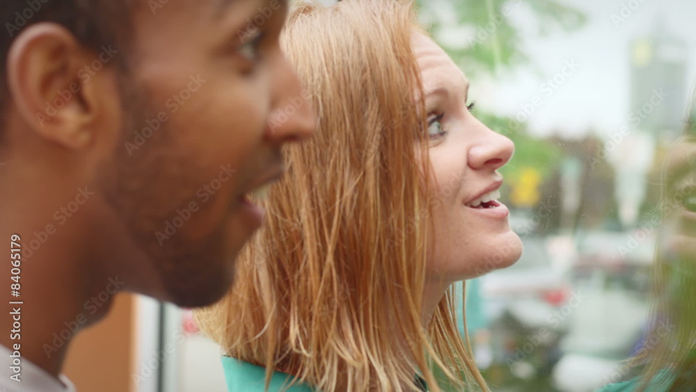Close up of a boyfriend and girlfriend window shopping during the day Close up of a boyfriend and girlfriend window shopping during the day