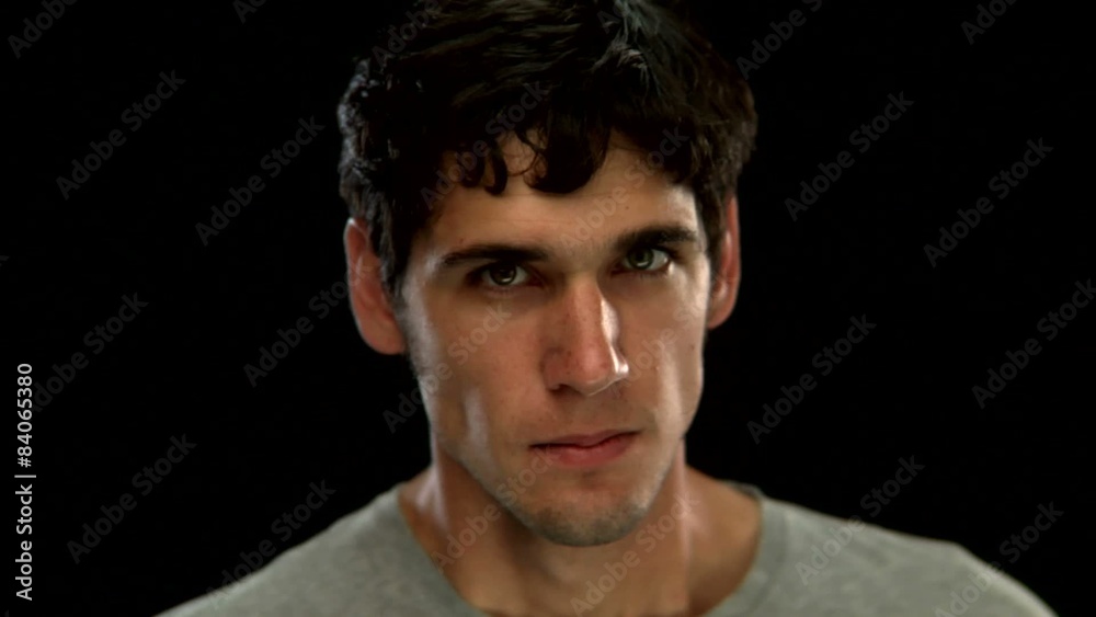 A young man makes an angry face A young man makes an angry face
