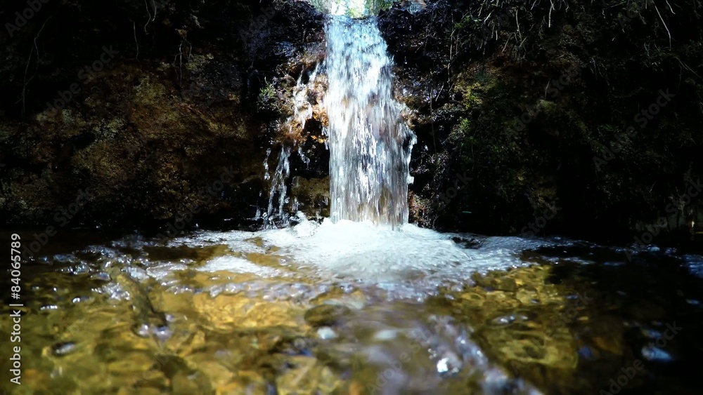 Pure fresh water waterfall in forest. Holy spring