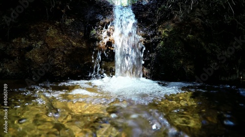 Pure fresh water waterfall in forest. Holy spring