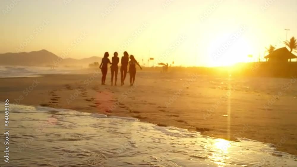 Young Brazilian women walk down a beach in Brazil Young Brazilian women walk down a beach in Brazil