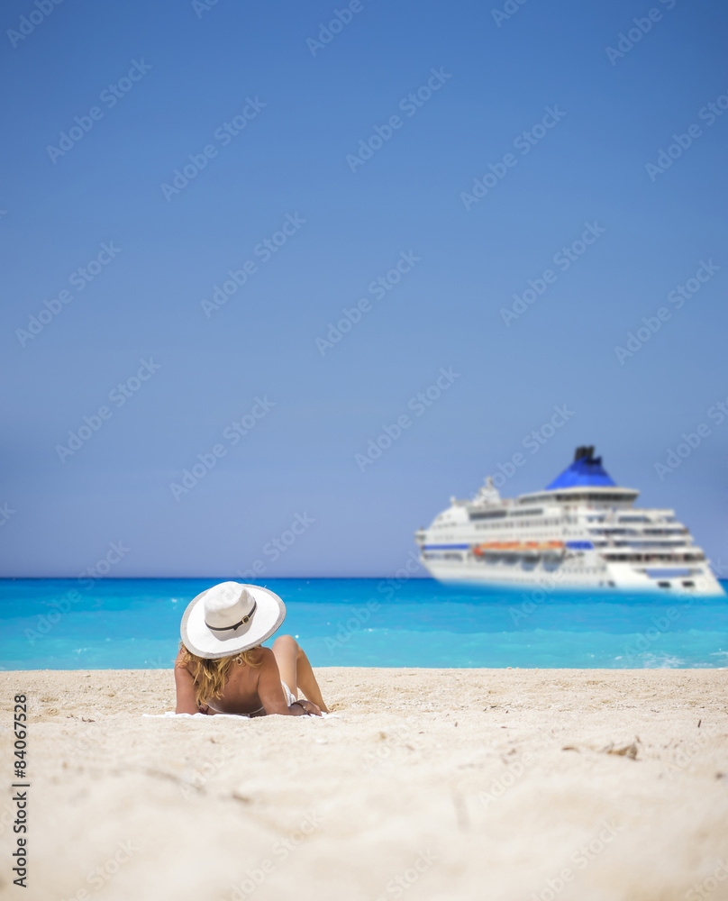 Woman relaxing on the famous Shipwreck beach in Zakynthos Woman relaxing on the famous Shipwreck beach in Zakynthos