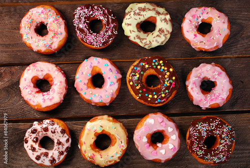 homemade colorful donuts on wooden background