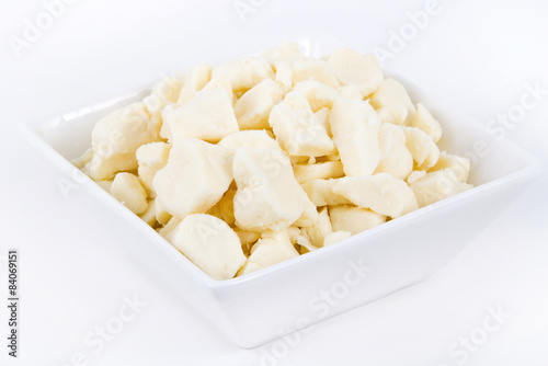 white dairy cheese curd in a bowl over white background