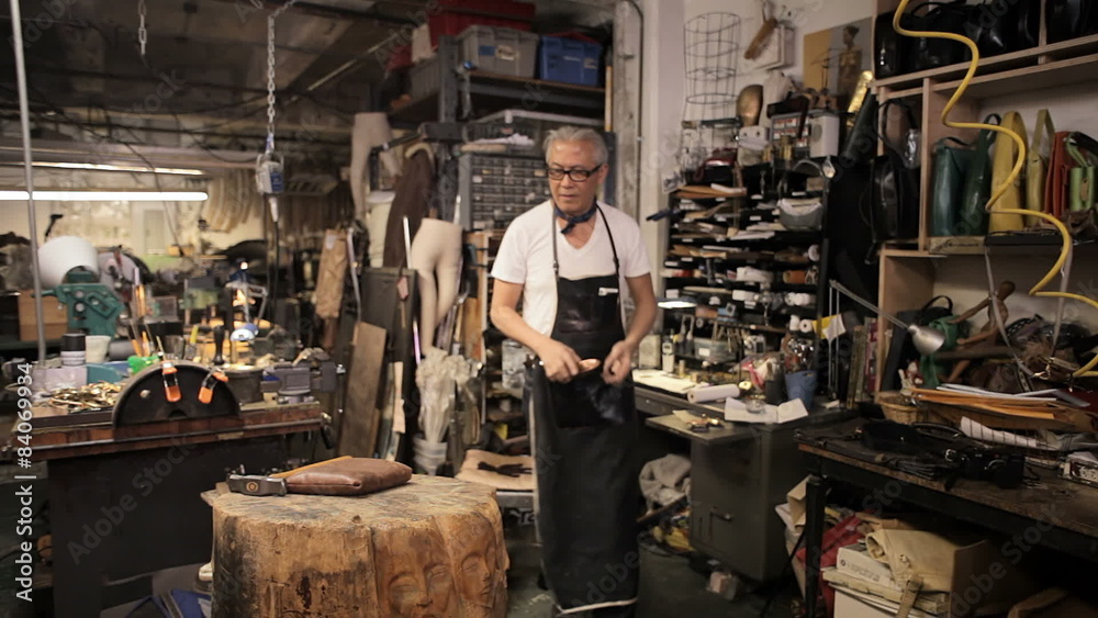 A designer works at his desk in his workshop