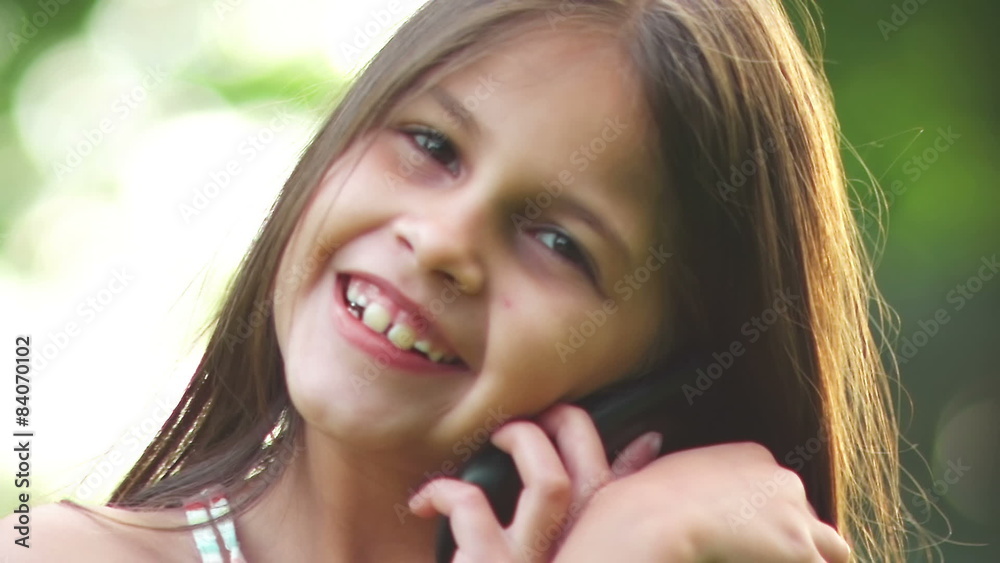 Adorable little girl talks on a cell phone. Adorable little girl talks on a cell phone.