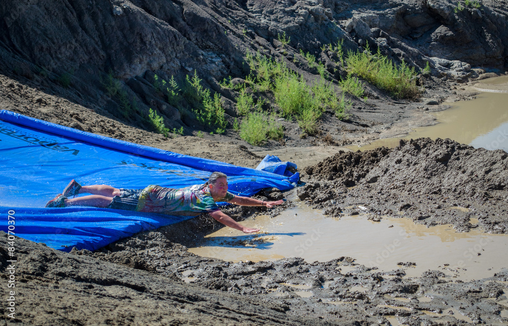 Mud Run Sliding face first on large slip & slide into mud water