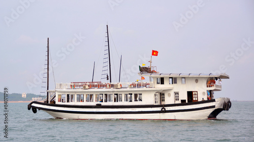 Tourist Junk Boat Cruises Halong Bay on a fine Spring Day, Vietn