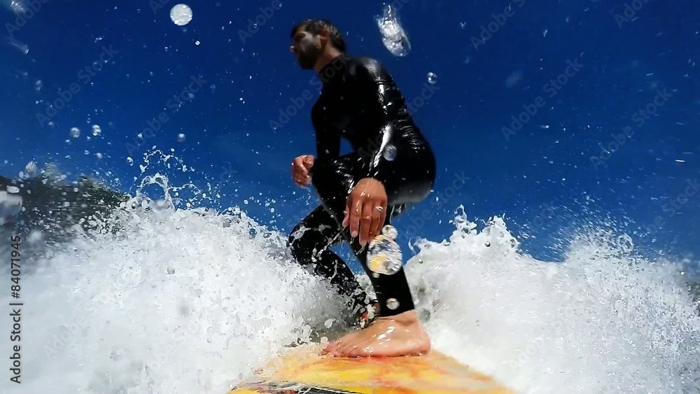 Young man enjoying the surfing in Waves.