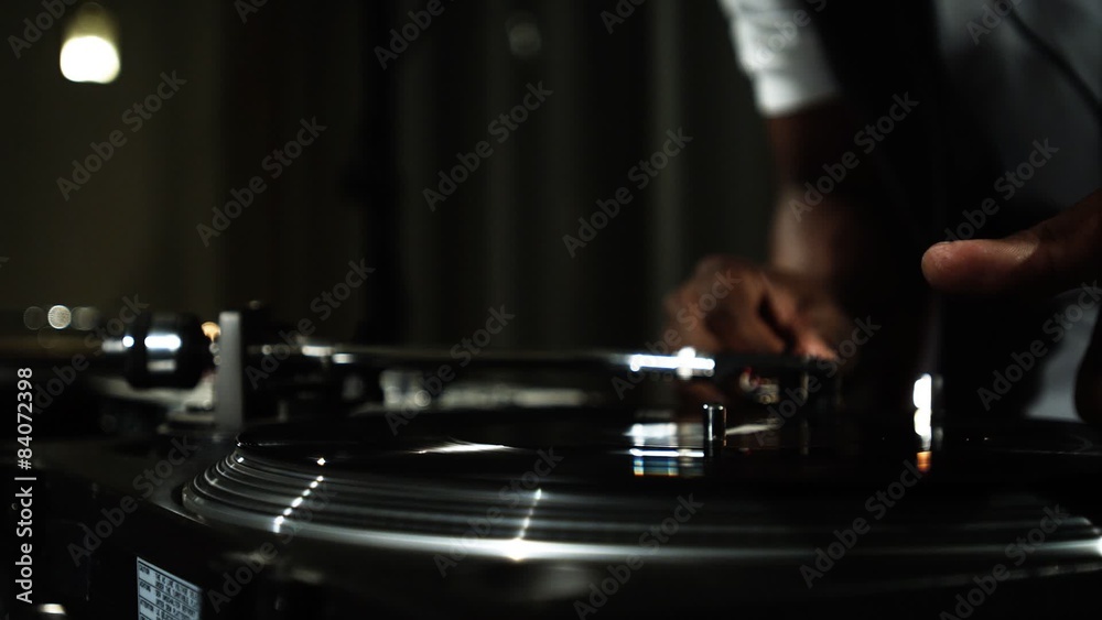 Close up of a DJ's hands spinning records at a party