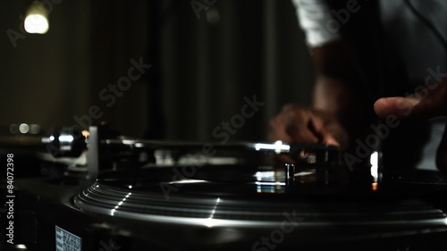 Close up of a DJ's hands spinning records at a party