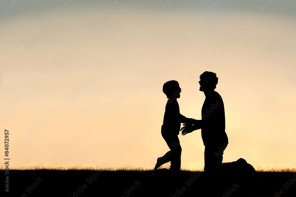 Silhouette of Happy Father and Son at Sunset