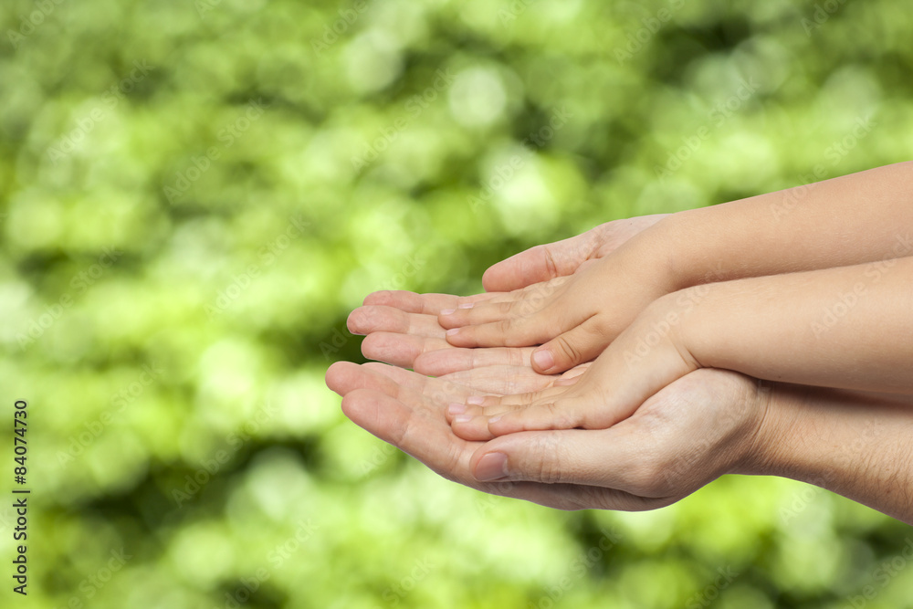 father and son holding hands on natural background father and son holding hands on natural background