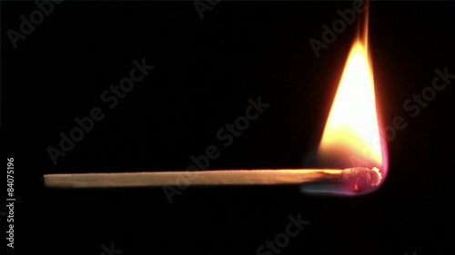 Close-Up footage of a match igniting and burning as it rotates