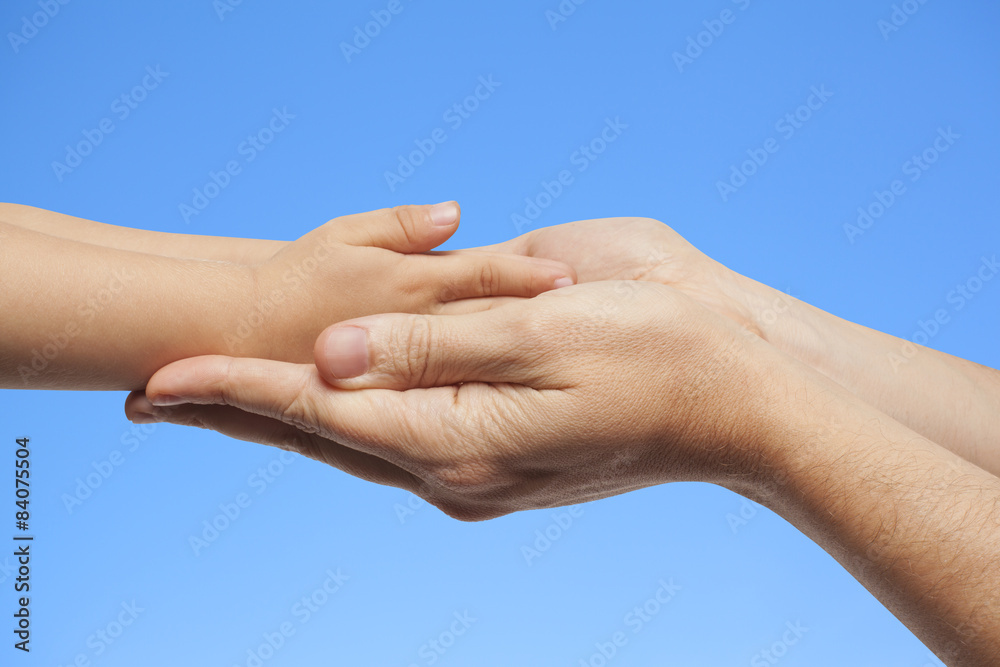 father and son holding hands on sky background