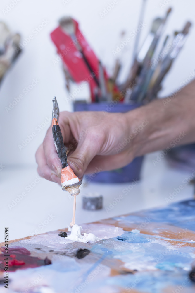 Fototapeta premium male hand adding paint - painting session.