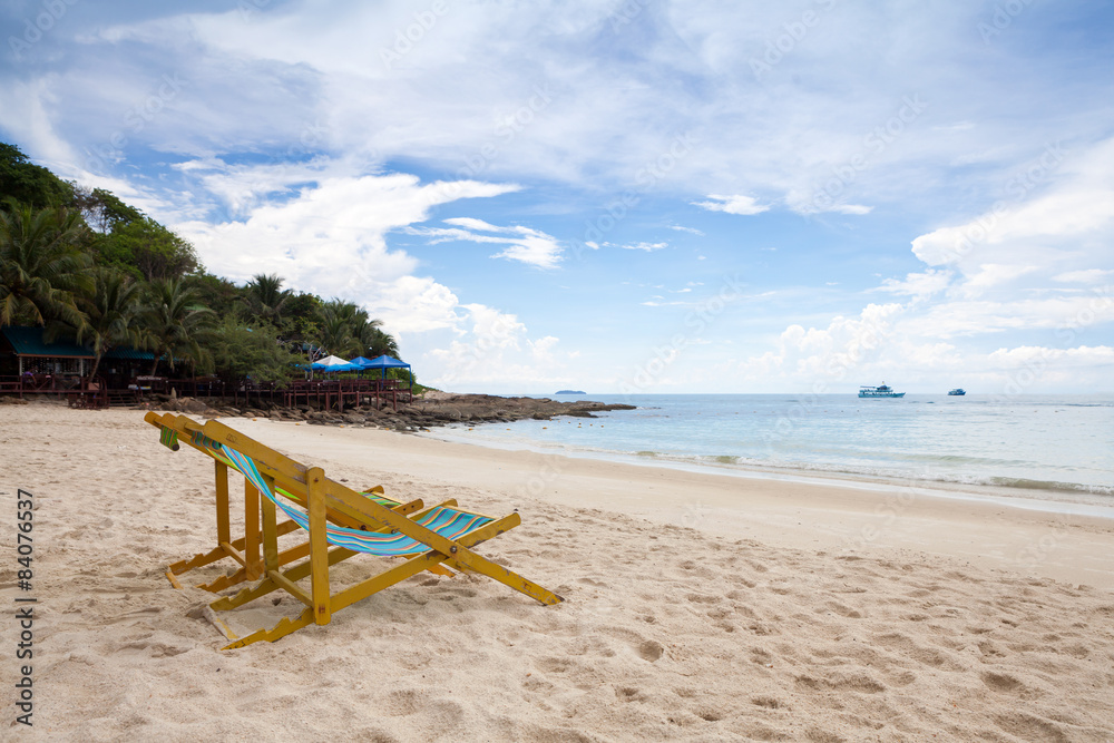 Beach chairs on the white sand beach with cloudy blue sky Beach chairs on the white sand beach with cloudy blue sky