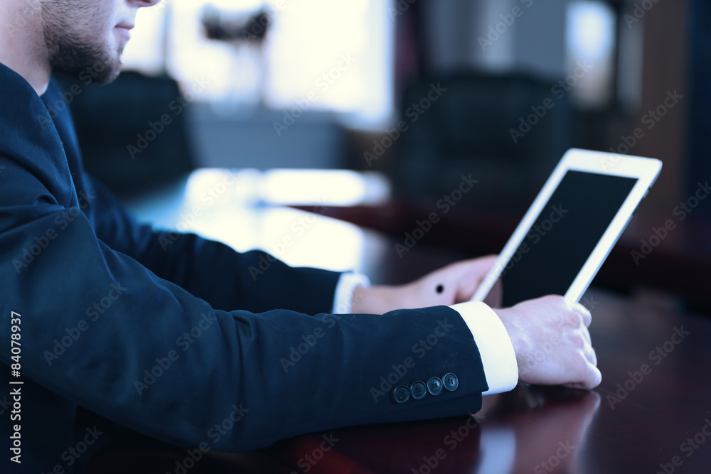 Businessman working with tablet in office, closeup Businessman working with tablet in office, closeup