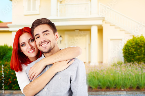 Loving couple near their house