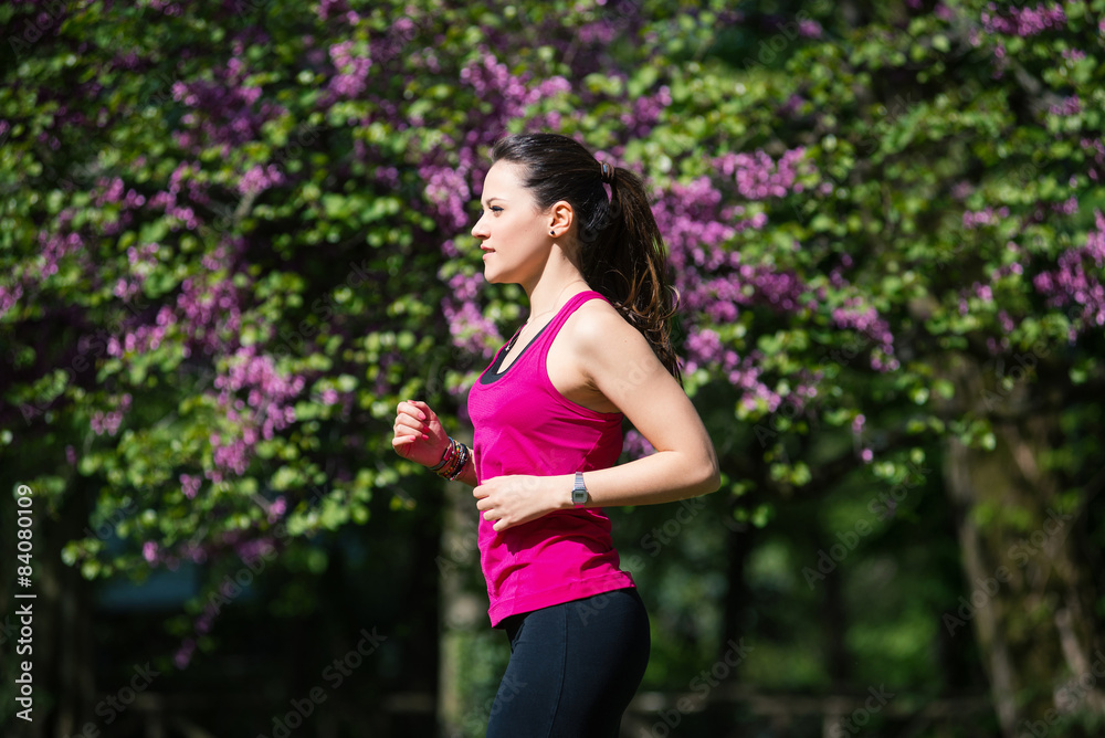 Young beautiful woman running outdoors in a park. Young beautiful woman running outdoors in a park.