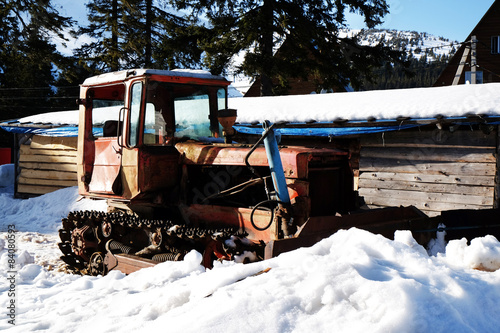 Old broken tractor over snow in wintertime