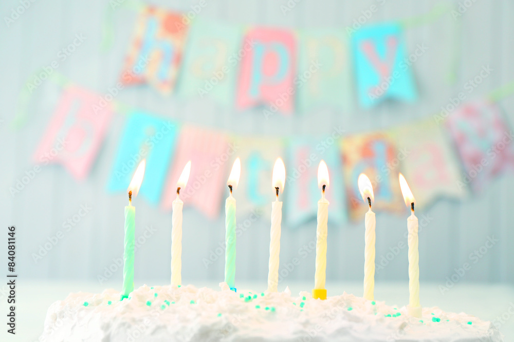 Birthday cake with candles on planks wall background Birthday cake with candles on planks wall background
