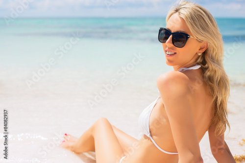 Young woman sunbathing on the beach