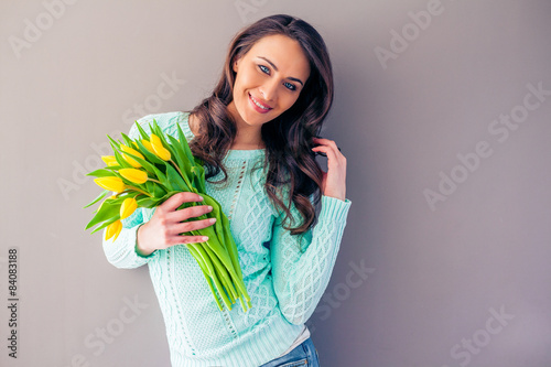 Beautiful casual woman with a tulip bouquet #84083188
