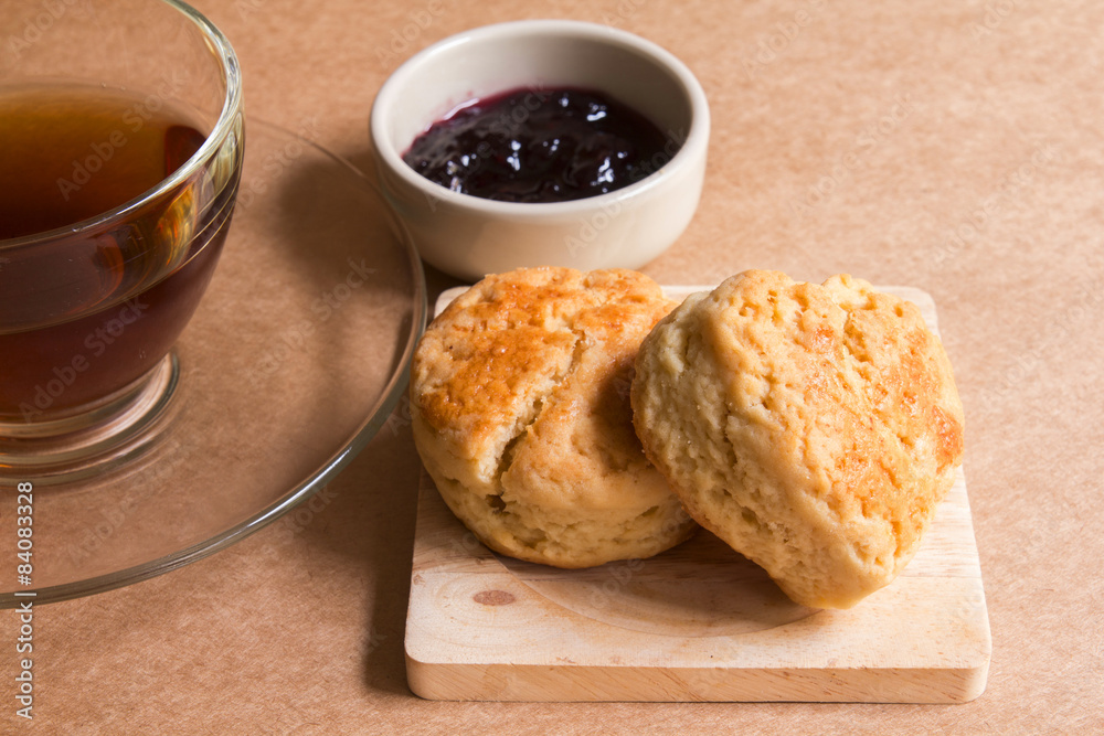 Scone with hot tea and blueberry jam. Scone with hot tea and blueberry jam.