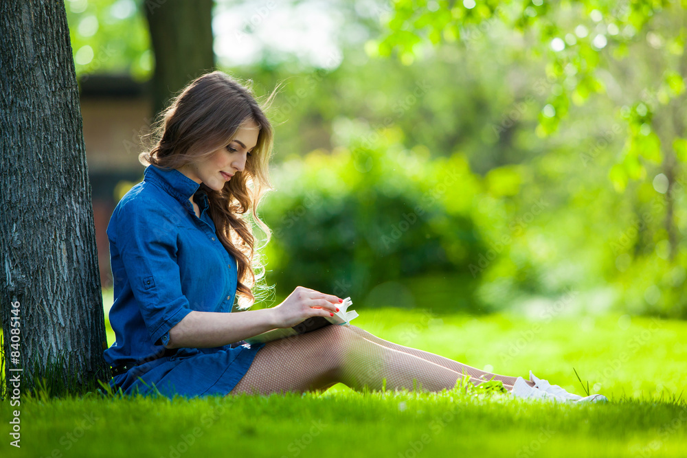Girl reading a book in park Girl reading a book in park