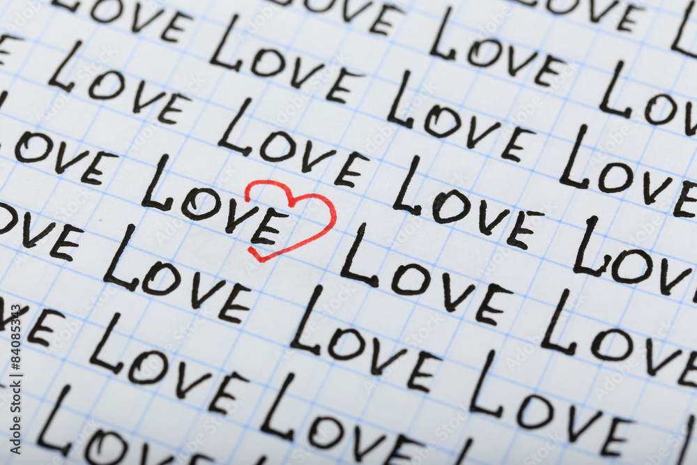 Words LOVE written on sheet of paper background Words LOVE written on sheet of paper background