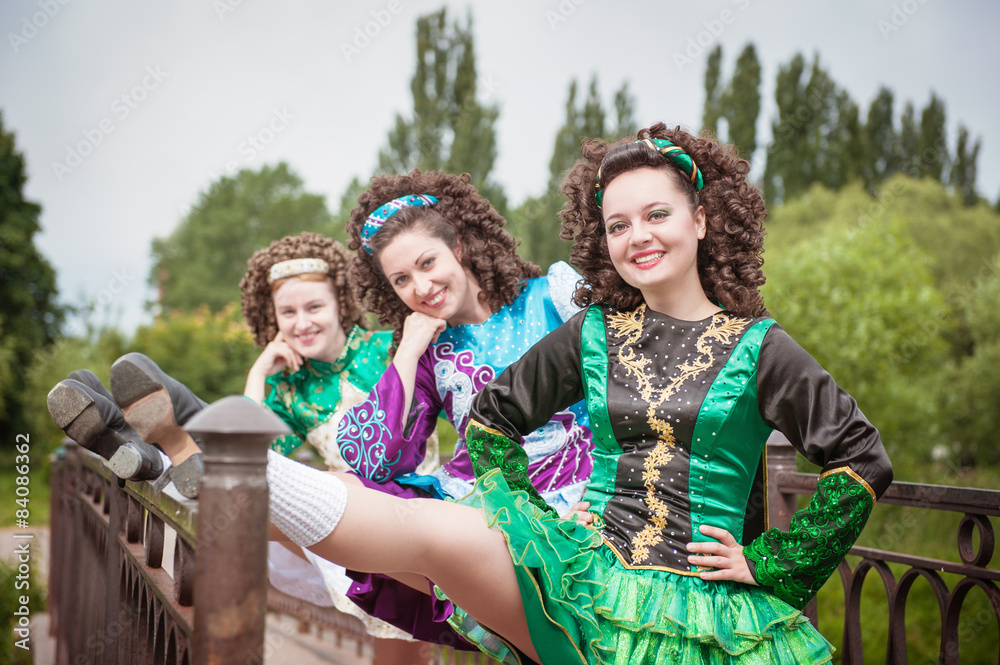 Three young beautiful girls in irish dance dress and wig posing
