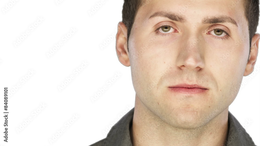 Man looks serious into the camera on a white background Man looks serious into the camera on a white background