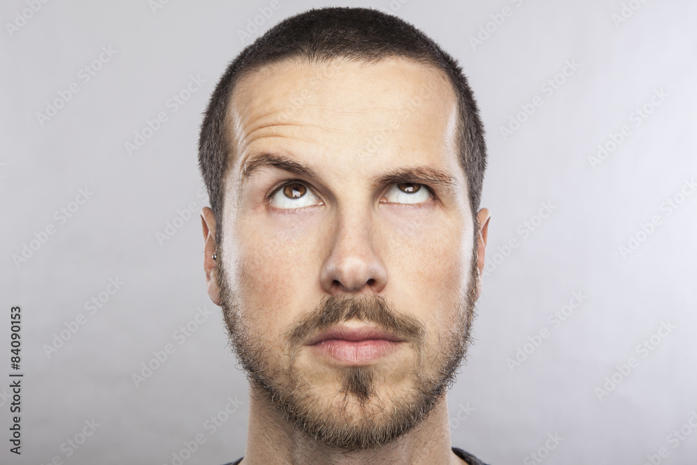 young beautiful man looking up, face expression
