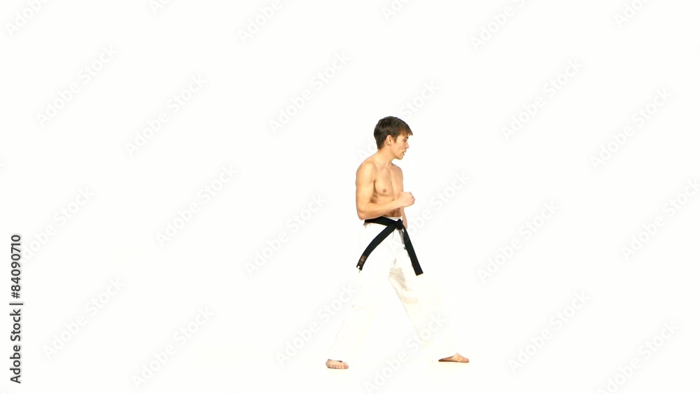 Karate or taekwondo man performs tricks Isolated on white Karate or taekwondo man performs tricks Isolated on white